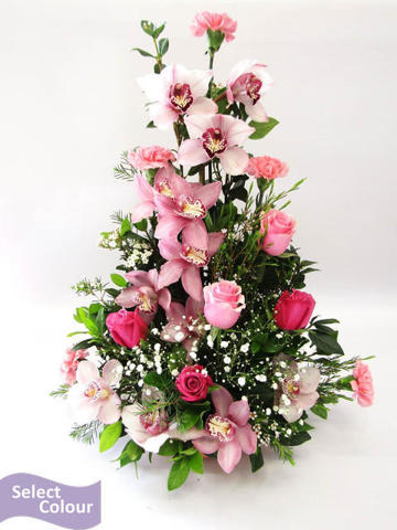Roses and orchids arranged in ceramic pot